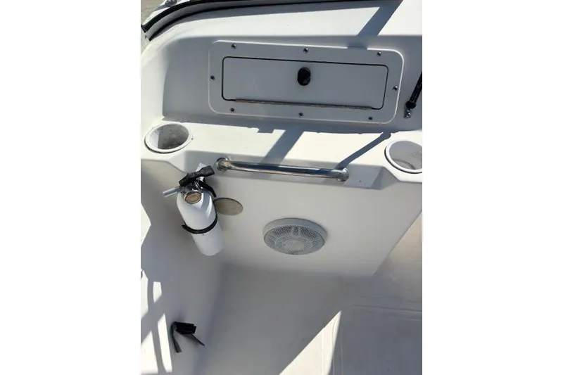 Slide: The Image of 2001 Sea Pro 190 Dual Console interior with storage, cup holders, and fire extinguisher. - 14