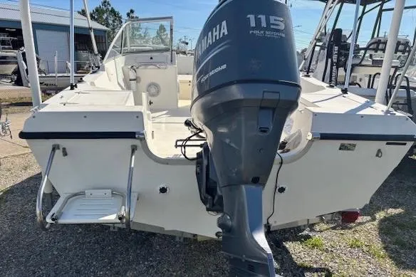 Slide: The Image of 2001 Sea Pro 190 Dual Console boat with Yamaha 115 outboard motor, parked outdoors. - 3