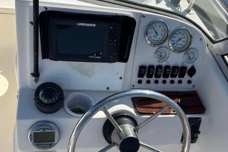 Slide: The Image of 2001 Sea Pro 190 Dual Console dashboard with gauges and Lowrance GPS system. - 5