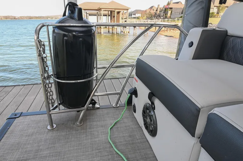 Slide: The Image of 2021 Harris Sunliner 230 boat interior with seating and lake view. - 10