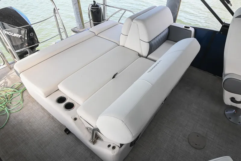 Slide: The Image of 2021 Harris Sunliner 230 boat interior with white seating and cup holders. - 17