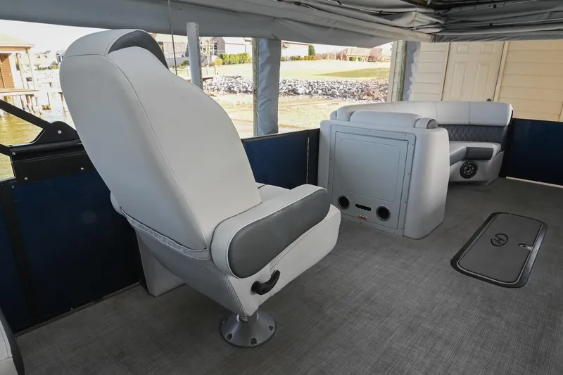 Slide: The Image of Interior of 2021 Harris Sunliner 230 boat with modern seating and storage. - 24