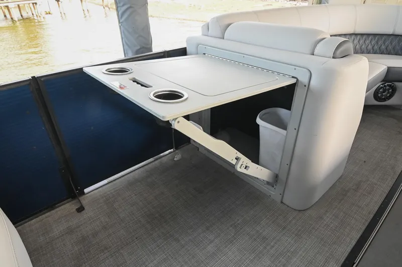 Slide: The Image of Interior of 2021 Harris Sunliner 230 boat with foldable table and cup holders. - 27