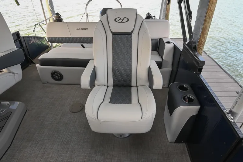 Slide: The Image of Interior of 2021 Harris Sunliner 230 boat with luxurious seating and cup holders. - 28