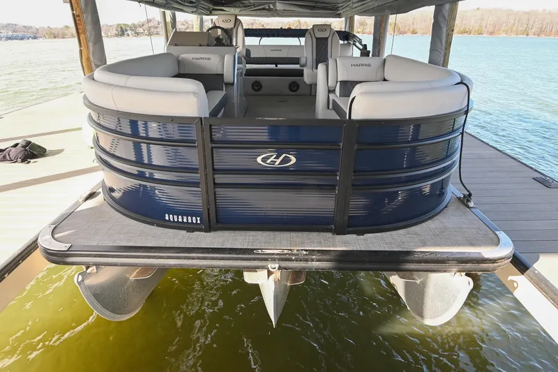 Slide: The Image of 2021 Harris Sunliner 230 pontoon boat docked on a sunny day. - 3