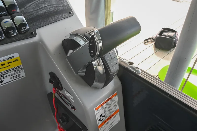 Slide: The Image of Control panel of 2021 Harris Sunliner 230 boat with throttle and switches. - 30