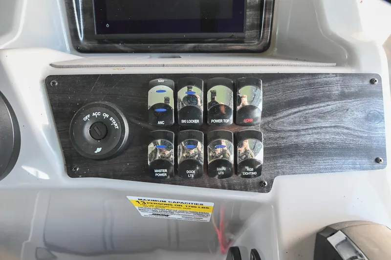 Slide: The Image of Control panel of 2021 Harris Sunliner 230 boat with various switches and ignition. - 32
