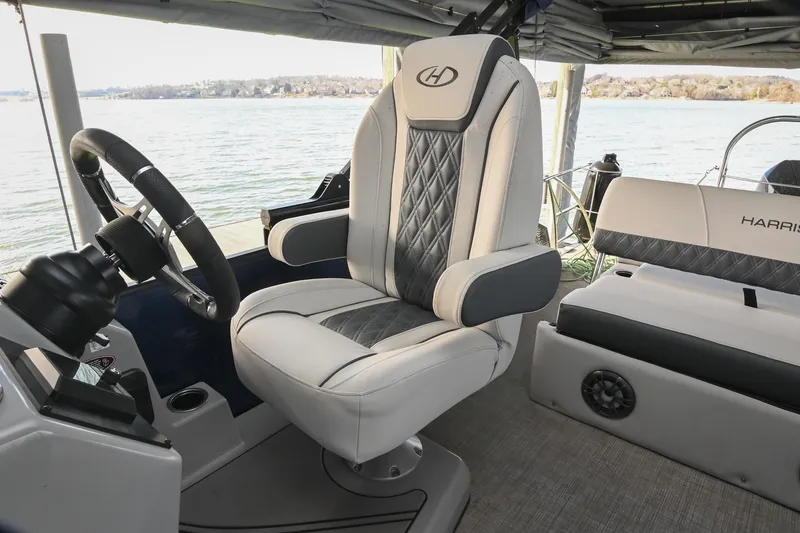 Slide: The Image of Captain's chair on 2021 Harris Sunliner 230 boat, featuring elegant design and waterfront view. - 34
