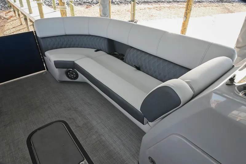 Slide: The Image of 2021 Harris Sunliner 230 boat interior with gray cushioned seating and carpeted floor. - 36