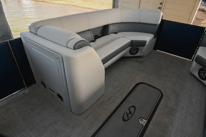 Slide: The Image of 2021 Harris Sunliner 230 pontoon boat interior with plush seating and modern design. - 37