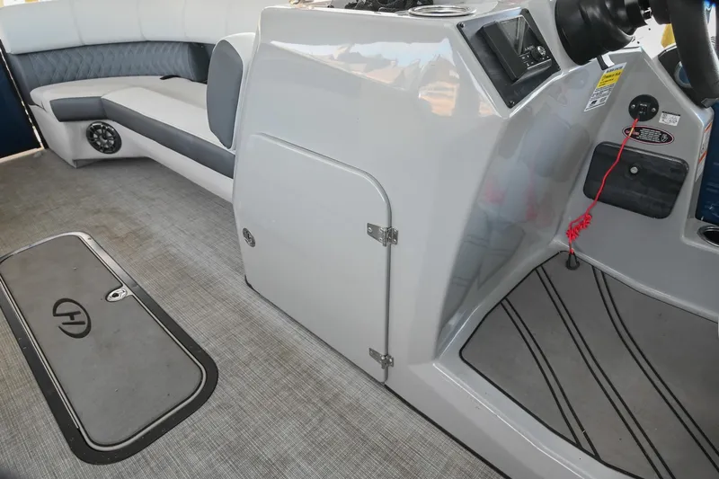 Slide: The Image of Interior of 2021 Harris Sunliner 230 boat with seating and control panel. - 39