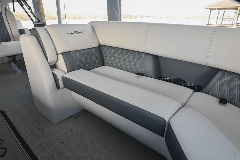 Slide: The Image of 2021 Harris Sunliner 230 boat interior with plush seating and cup holders. - 40