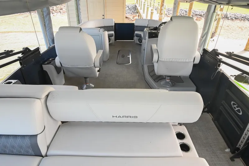 Slide: The Image of Interior of 2021 Harris Sunliner 230 pontoon boat with plush seating and modern design. - 6