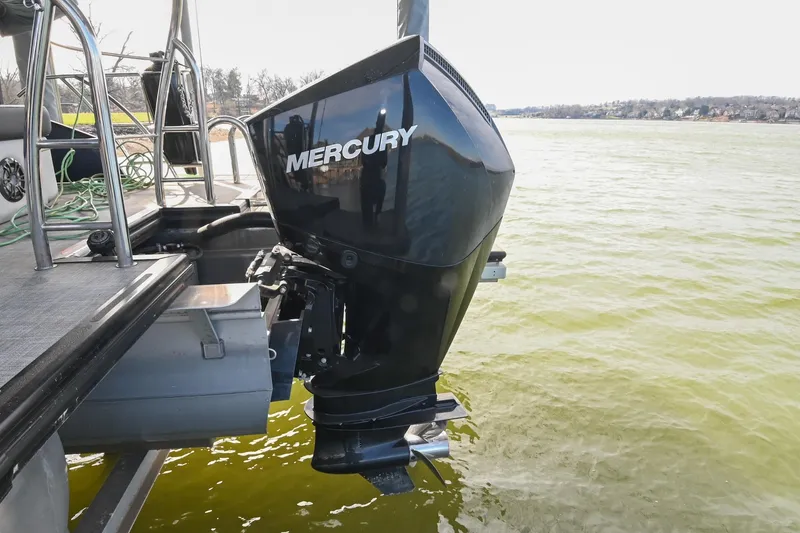 Slide: The Image of 2021 Harris Sunliner 230 with Mercury outboard motor on a lake. - 8