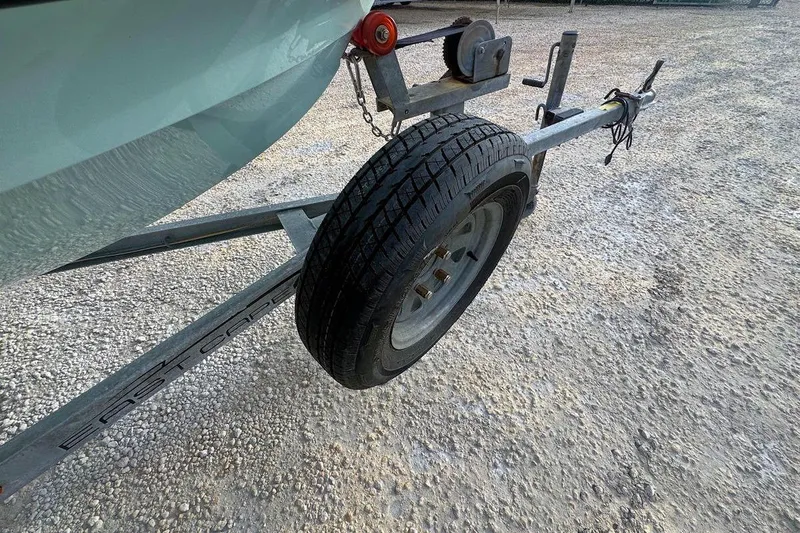 Slide: The Image of 2021 East Cape Glide boat trailer with tire on gravel surface. - 10