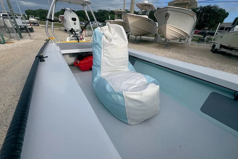 Slide: The Image of 2021 East Cape Glide boat with a bean bag seat on deck. - 12