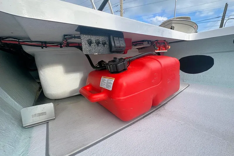 Slide: The Image of 2021 East Cape Glide boat interior with red fuel tank and wiring. - 13