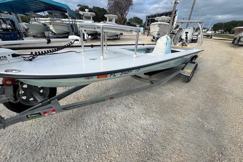 Slide: The Image of 2021 East Cape Glide boat on trailer in a marina setting. - 3