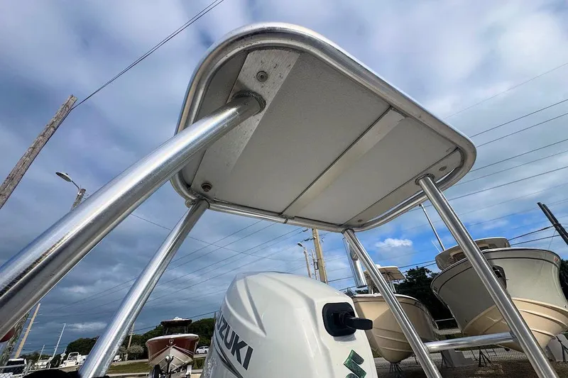 Slide: The Image of 2021 East Cape Glide boat with Suzuki engine, viewed from below, showcasing T-top structure. - 6