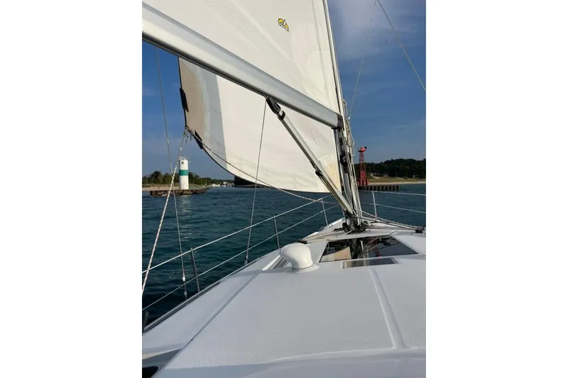 Slide: The Image of Sailing on a 2011 Hunter 39 yacht near a lighthouse and calm waters. - 11
