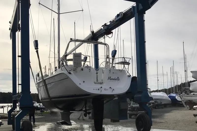 Slide: The Image of 2011 Hunter 39 sailboat lifted by crane in marina. - 12