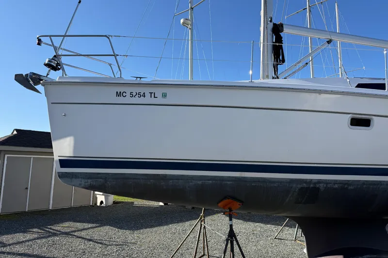 Slide: The Image of Sailboat Hunter 39, 2011 model, on stands in a yard, clear sky background. - 13