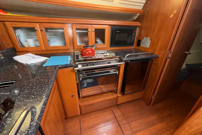 Slide: The Image of Luxurious 2011 Hunter 39 yacht kitchen with wood cabinetry and modern appliances. - 17