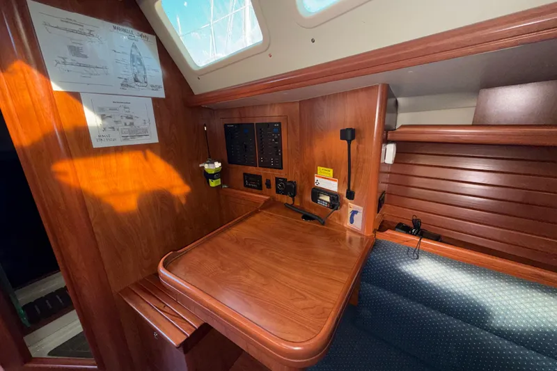 Slide: The Image of 2011 Hunter 39 yacht interior with navigation station and wooden cabinetry. - 18