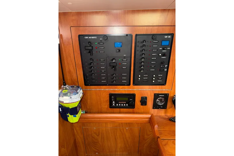 Slide: The Image of Control panel of a 2011 Hunter 39 sailboat with electrical switches and equipment. - 19