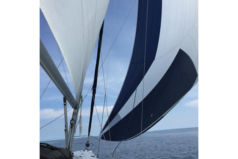 Slide: The Image of Sailing on a 2011 Hunter 39 yacht with blue and white sails over calm sea. - 2
