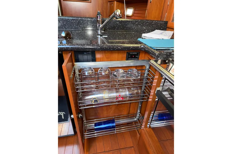 Slide: The Image of Pull-out kitchen cabinet with glass storage in 2011 Hunter 39 yacht. - 24
