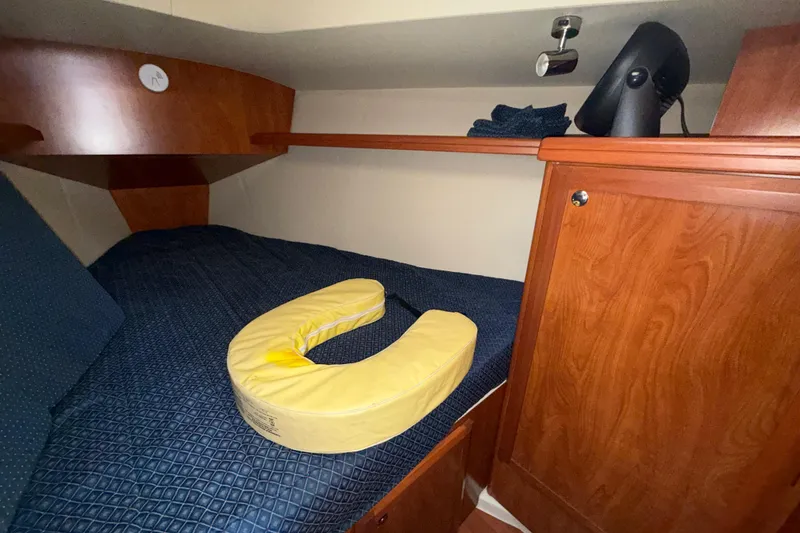 Slide: The Image of Cozy cabin interior of 2011 Hunter 39 sailboat with wooden finish and bedding. - 28