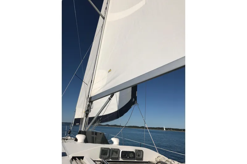 Slide: The Image of Sailing on a 2011 Hunter 39 yacht with white sails against a clear blue sky. - 3