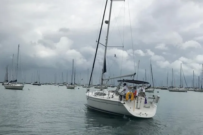 Slide: The Image of Sailboat Hunter 39 (2011) on calm waters under cloudy skies. - 4