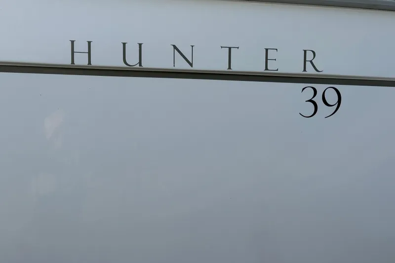 Slide: The Image of Close-up of 2011 Hunter 39 model nameplate on white surface. - 40