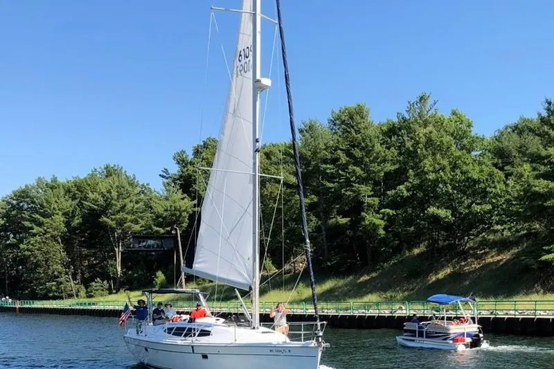 Slide: The Image of Sailboat Hunter 39, 2011 model, cruising on a sunny day near a forested shoreline. - 8