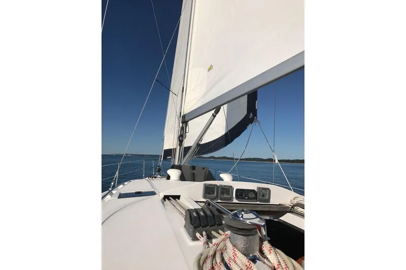 Slide: The Image of Sailing on a 2011 Hunter 39 yacht with clear blue skies and calm waters. - 9