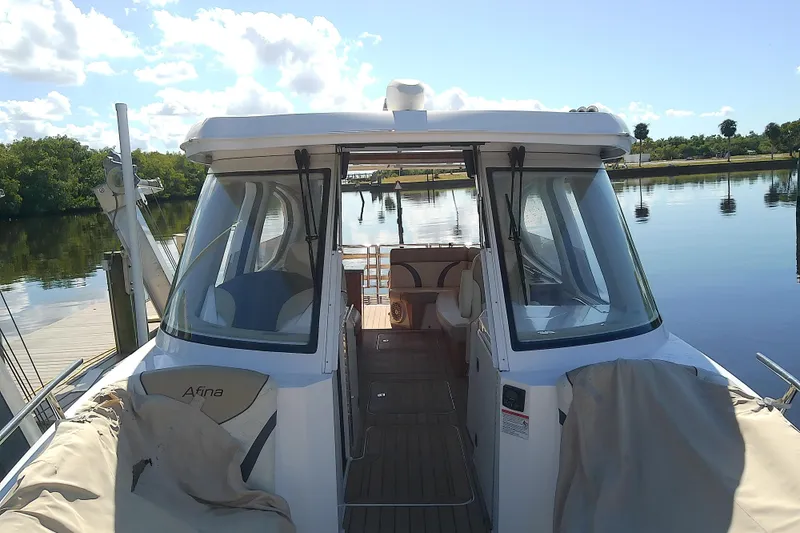 Slide: The Image of 2019 Floe Craft 3950C Aquafina boat docked on a serene lake. - 11