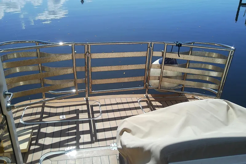 Slide: The Image of 2019 Floe Craft 3950C Aquafina boat deck with metal railing and calm water reflection. - 13