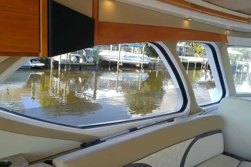 Slide: The Image of Interior view of 2019 Floe Craft 3950C Aquafina boat with large windows overlooking water. - 17