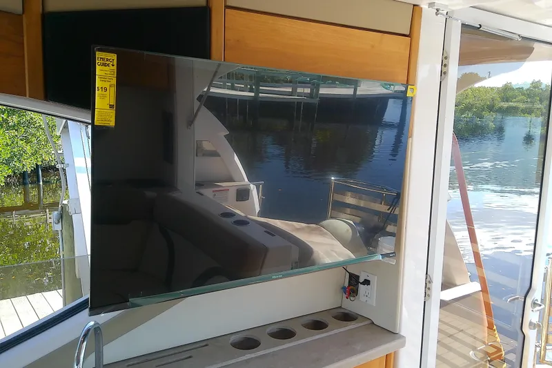 Slide: The Image of Flat-screen TV on 2019 Floe Craft 3950C Aquafina yacht, docked by water. - 19