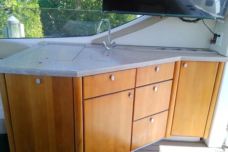 Slide: The Image of 2019 Floe Craft 3950C Aquafina boat kitchen with wooden cabinets and countertop. - 21