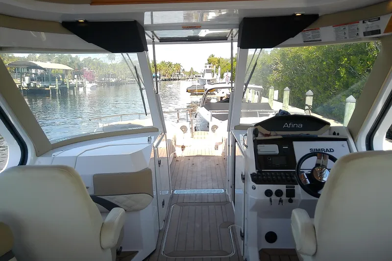 Slide: The Image of Interior view of 2019 Floe Craft 3950C Aquafina boat, featuring helm and waterway. - 28