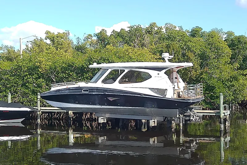 Slide: The Image of 2019 Floe Craft 3950C Aquafina boat docked near lush greenery. - 4