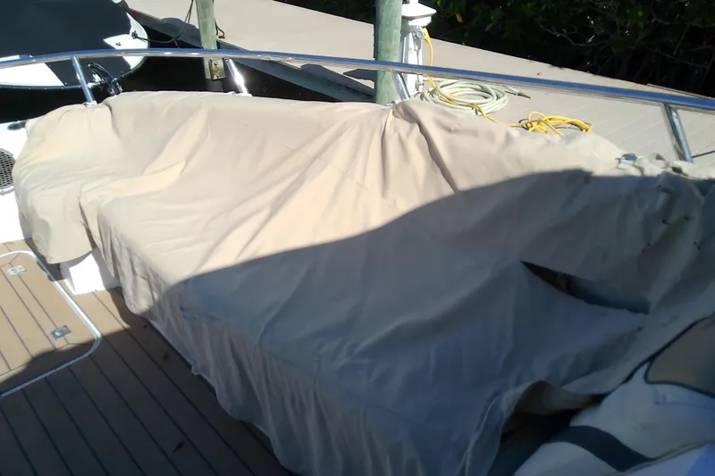 Slide: The Image of 2019 Floe Craft 3950C Aquafina boat covered with beige tarp on deck. - 48