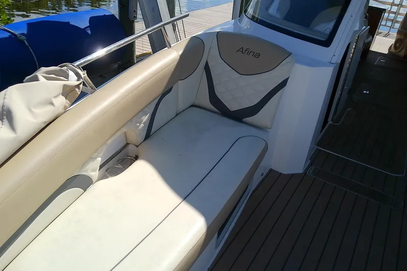 Slide: The Image of 2019 Floe Craft 3950C Aquafina boat interior with beige seating and wooden deck. - 52