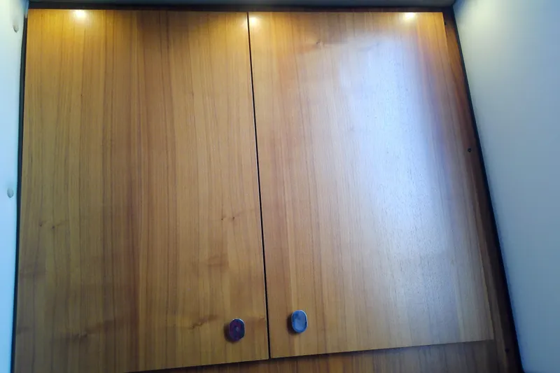 Slide: The Image of Wooden cabinet doors with overhead lighting in a 2019 Floe Craft 3950C Aquafina. - 69