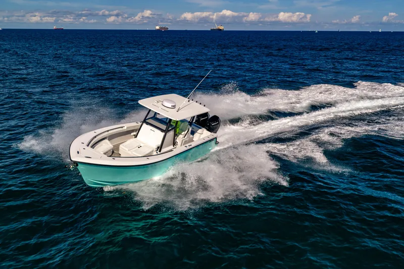 Slide: The Image of 2026 Reef Runner 340 boat cruising on open ocean with clear skies. - 1
