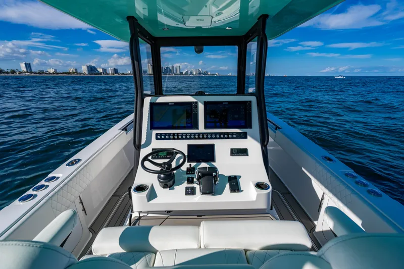 Slide: The Image of Cockpit view of 2026 Reef Runner 340 boat with modern navigation system on open water. - 11