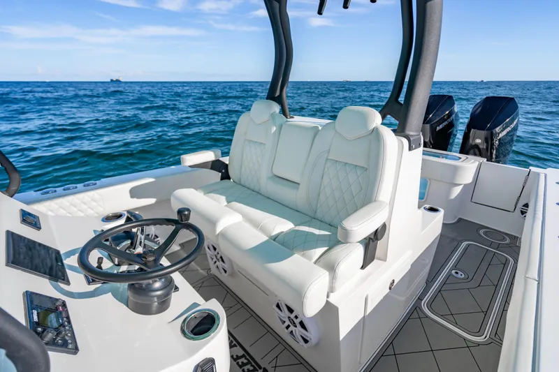 Slide: The Image of Luxury interior of 2026 Reef Runner 340 boat with white seating and ocean view. - 12